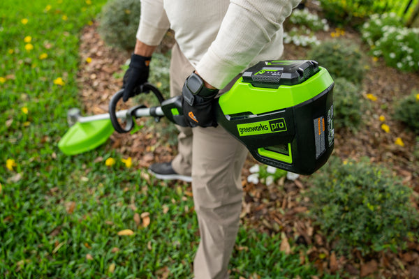 Man using Greenworks string trimmer